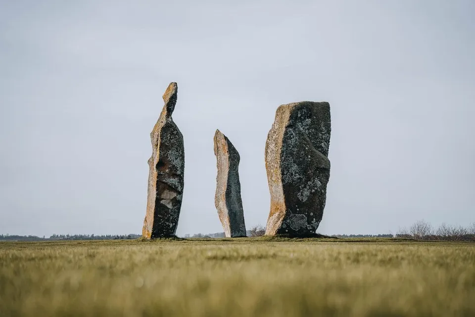 The three Lundin standing stones against the pale sky