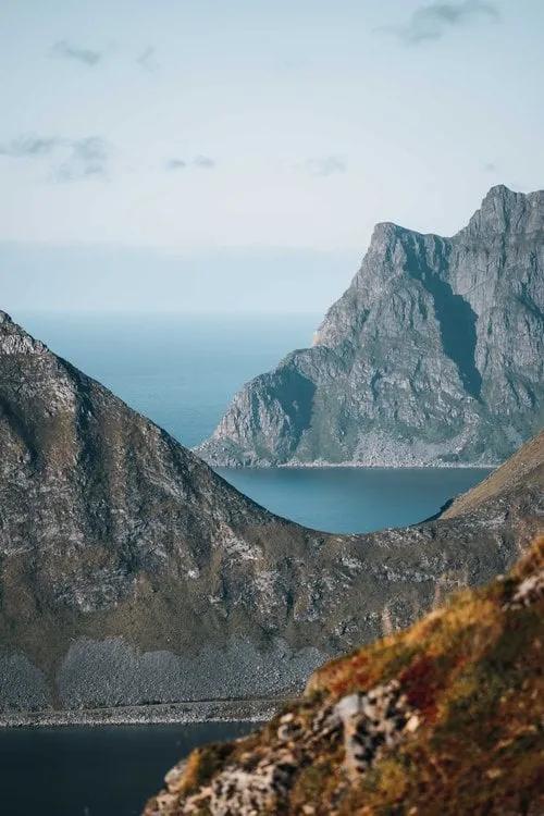 Eine steile Felswand fällt direkt in den Fjord ab